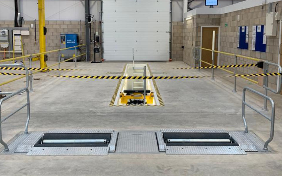 The vehicle inspection pit working area, equipped with safety barriers, roller shutter doors, commercial roller brake tester and a market-leading vehicle servicing and inspection pit