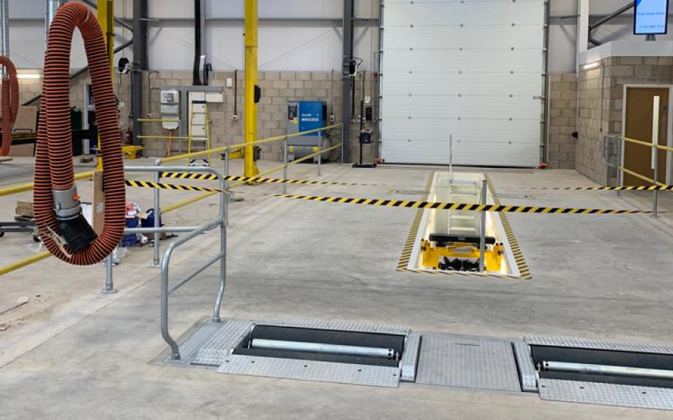 New vehicle servicing inspection pit in situ, alongside the client's existing fixed 2-post lift which was removed and reinstalled by CCS Garage Equipment