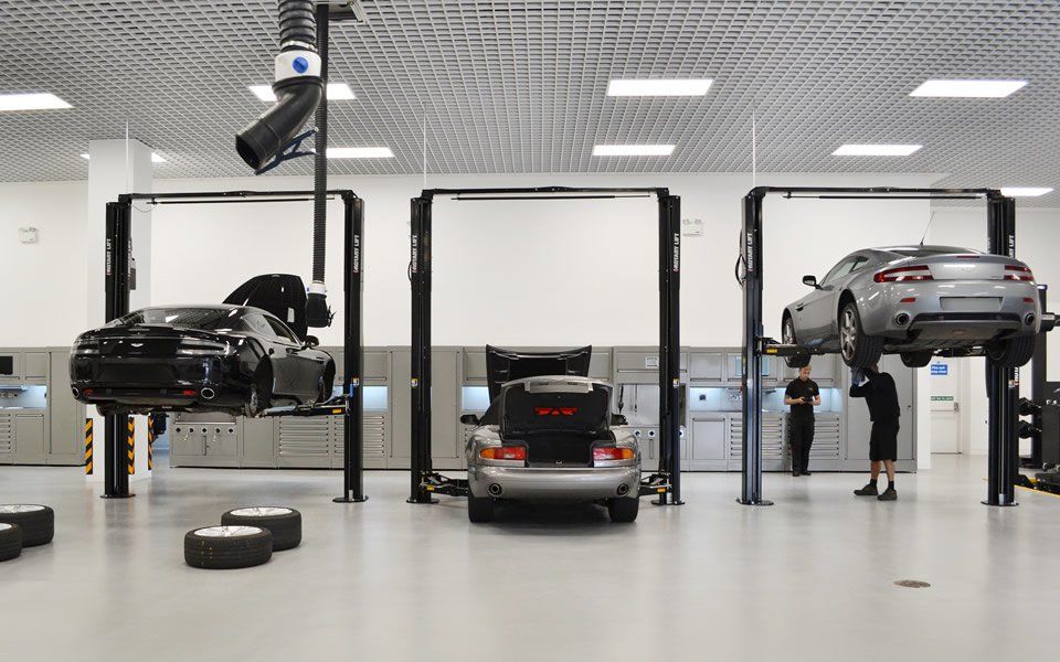 2-post vehicle lifts & LEV system operated by workshop engineers at Aston Martin Cheltenham