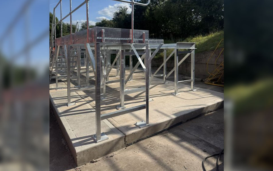 Galvanised steel staircase with railings integrated into wash ramp.