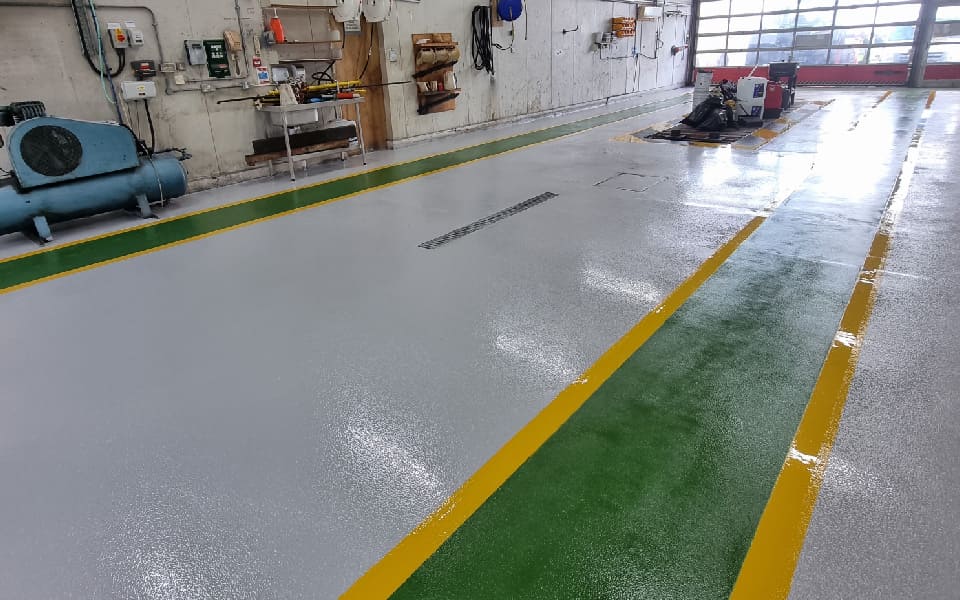 Installation of heavy-duty epoxy resin floor paint with anti-slip coating at East Midlands Airport by CCS Garage Equipment