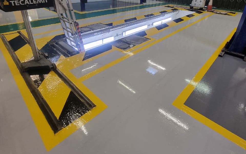 Potential hazard areas in the vehicle maintenance workshop were demarked using yellow and black epoxy resin floor paint by CCS Garage Equipment at East Midlands Airport