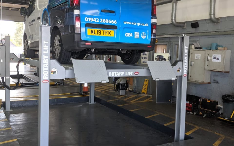 Photo of completed installation of 4-post MOT bay, featuring brake testers, headlamp aligner and safety markings
