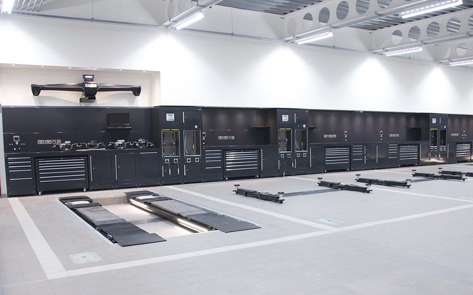 2-post in-ground vehicle lifts and bespoke Dura workshop furniture installed by CCS Garage Equipment for Jaguar Land Rover dealership in Battersea