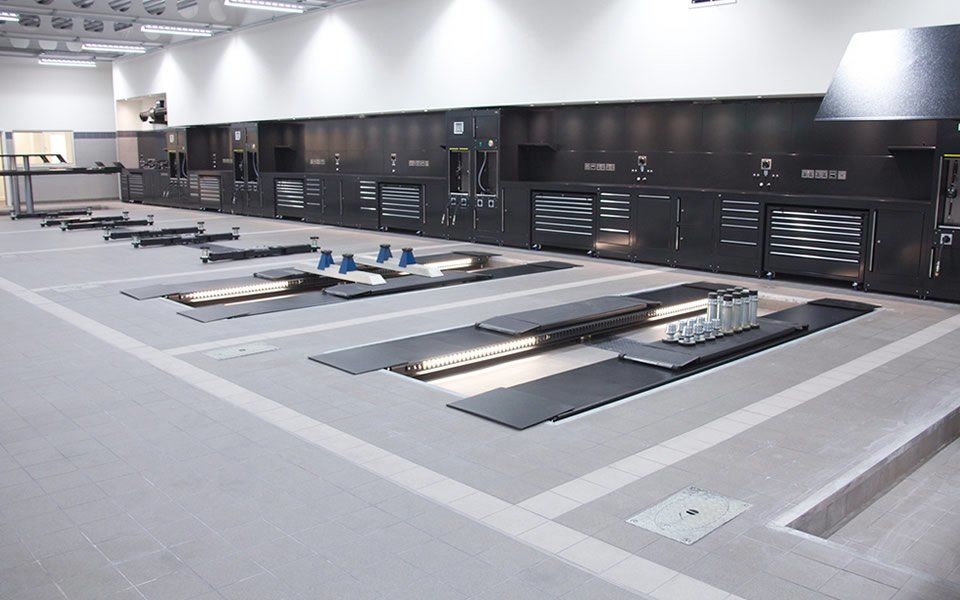 Bespoke Dura workshop furniture with integrated LED lights, data and power ports and ancillary equipment installed at Jaguar Land Rover, Battersea in London