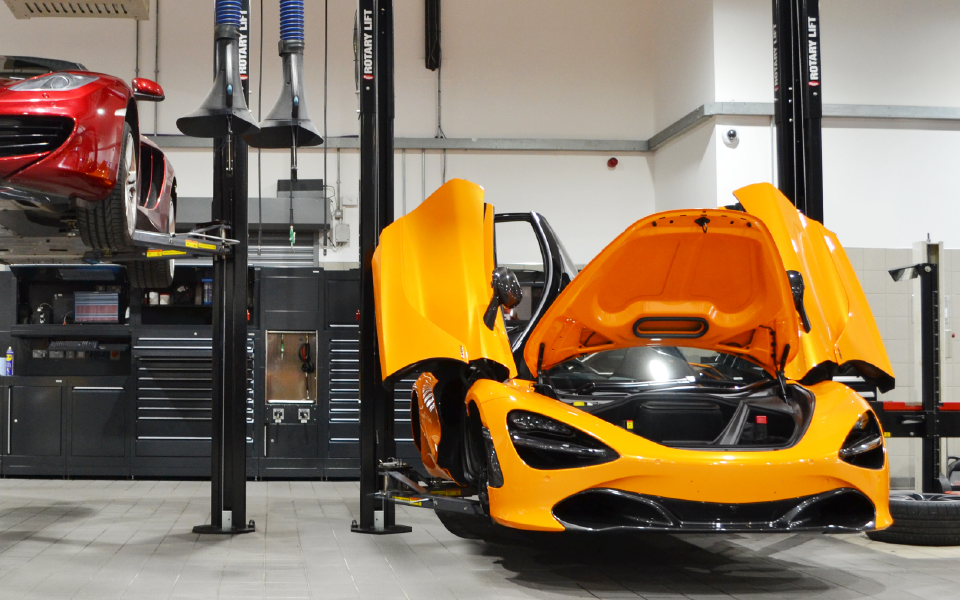 Fixed 2-post vehicle lifts by Rotary, together with ancillary air and LEV extraction equipment at McLaren dealership in Ascot, Berkshire