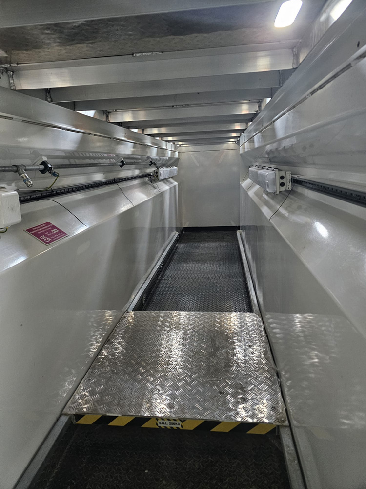 Inside of new in-ground vehicle inspection pit featuring anti-slip flooring.