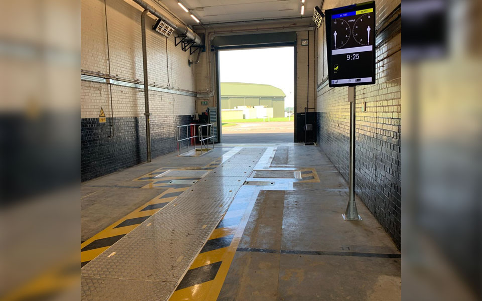 military vehicle inspection and test lane at this UK air base installed by CCS featuring black and yellow safety markings.