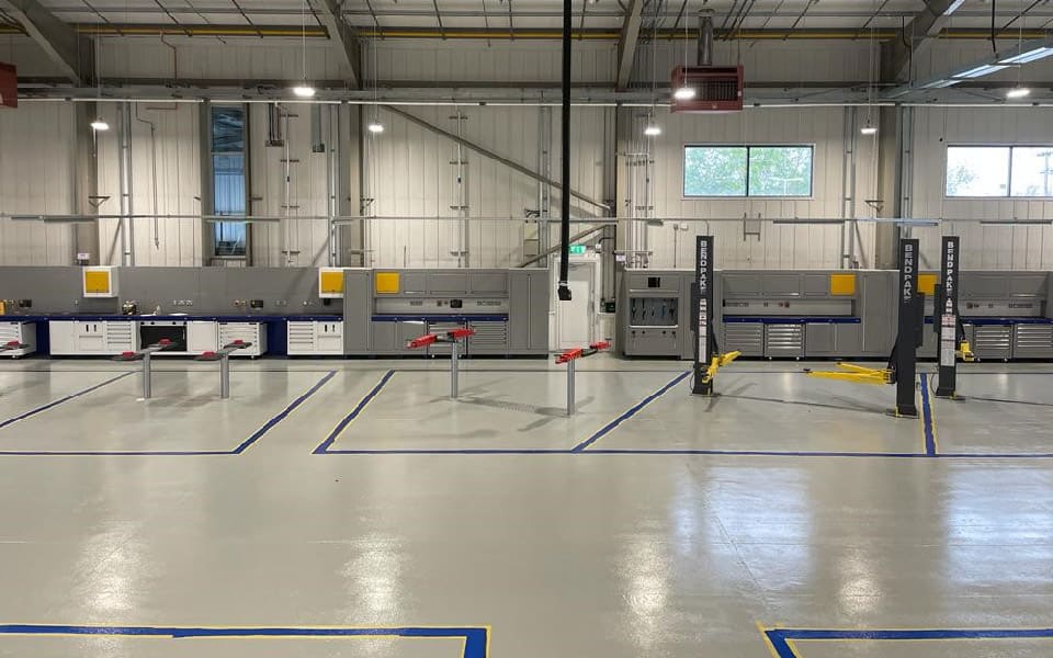 Anti-slip resin coated floor surface and floor markings applied to workshop floor