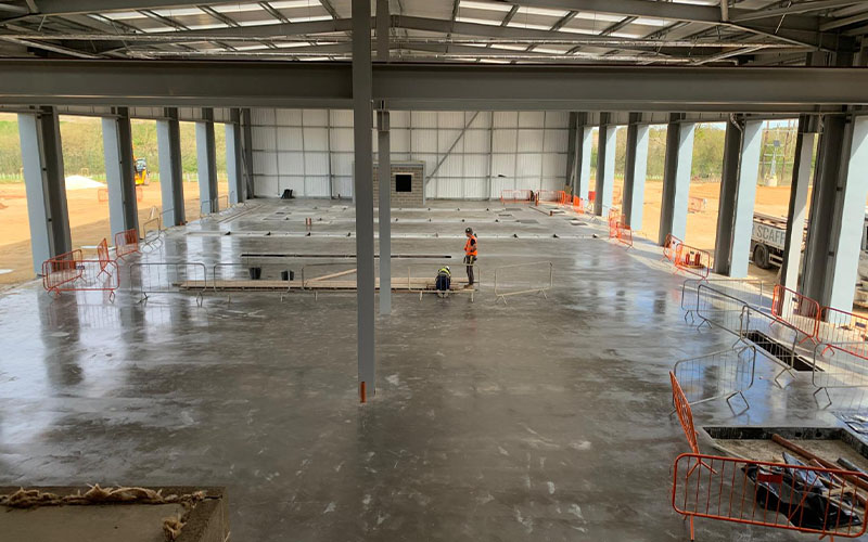 Floor slab is in place following initial groundworks to install cassettes for in-ground equipment for vehicle maintenance unit.