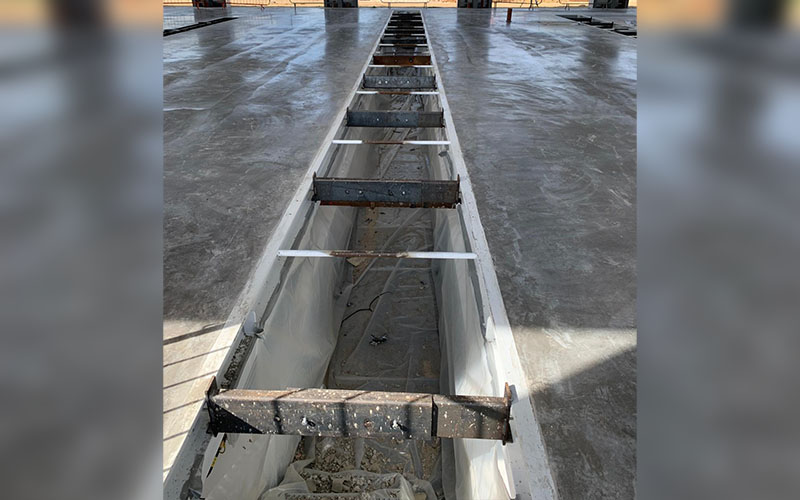 In-ground piston lifts cassette and groundworks are secured in readiness for the next phase of installation at TJ Morris Home Bargins new vehicle maintenance unit.
