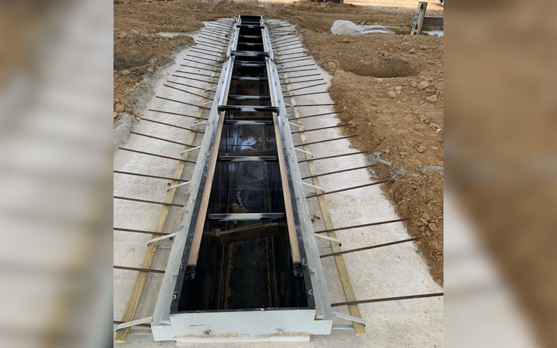 Continued installation of an in-ground piston lift installed by CCS Garage Equipment.