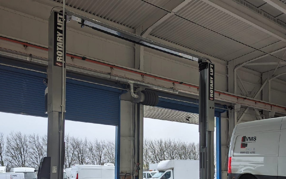 Photo shows installation of fixed 2-post vehicle lift by CCS’ garage equipment team for national vehicle rental company VMS Vehicle Hire