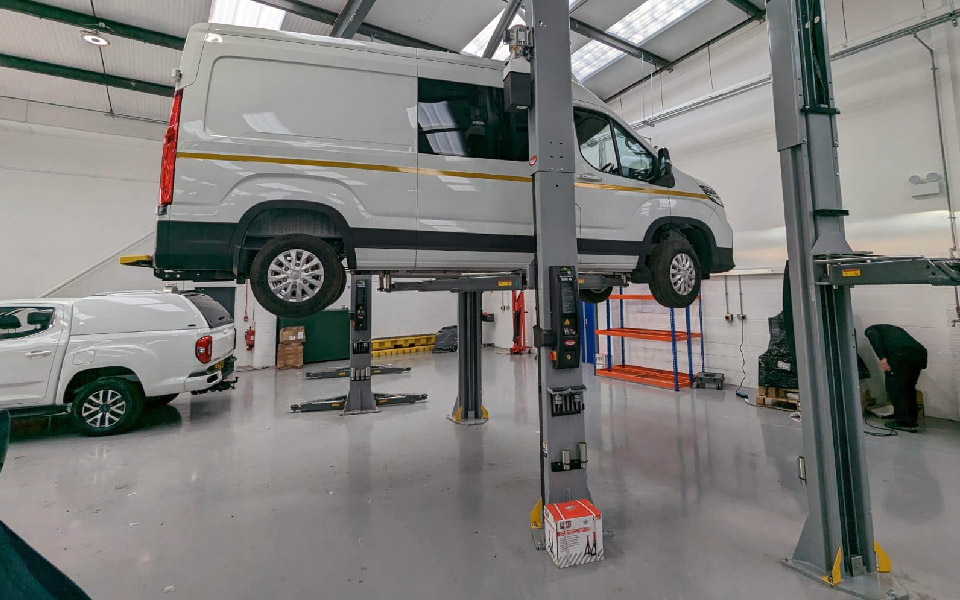 Photo shows fixed, 2-post vehicle lifts being installed, tested and commissioned by CCS Garage Equipment for VMS Vehicle Hire’s Stevenage