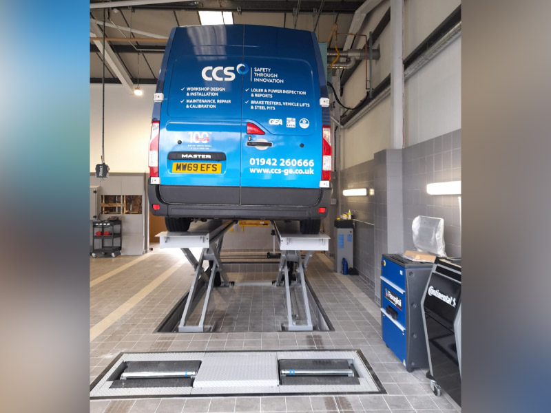 Class IV MOT bay with a recessed scissor vehicle lift brake tester and headlamp tester