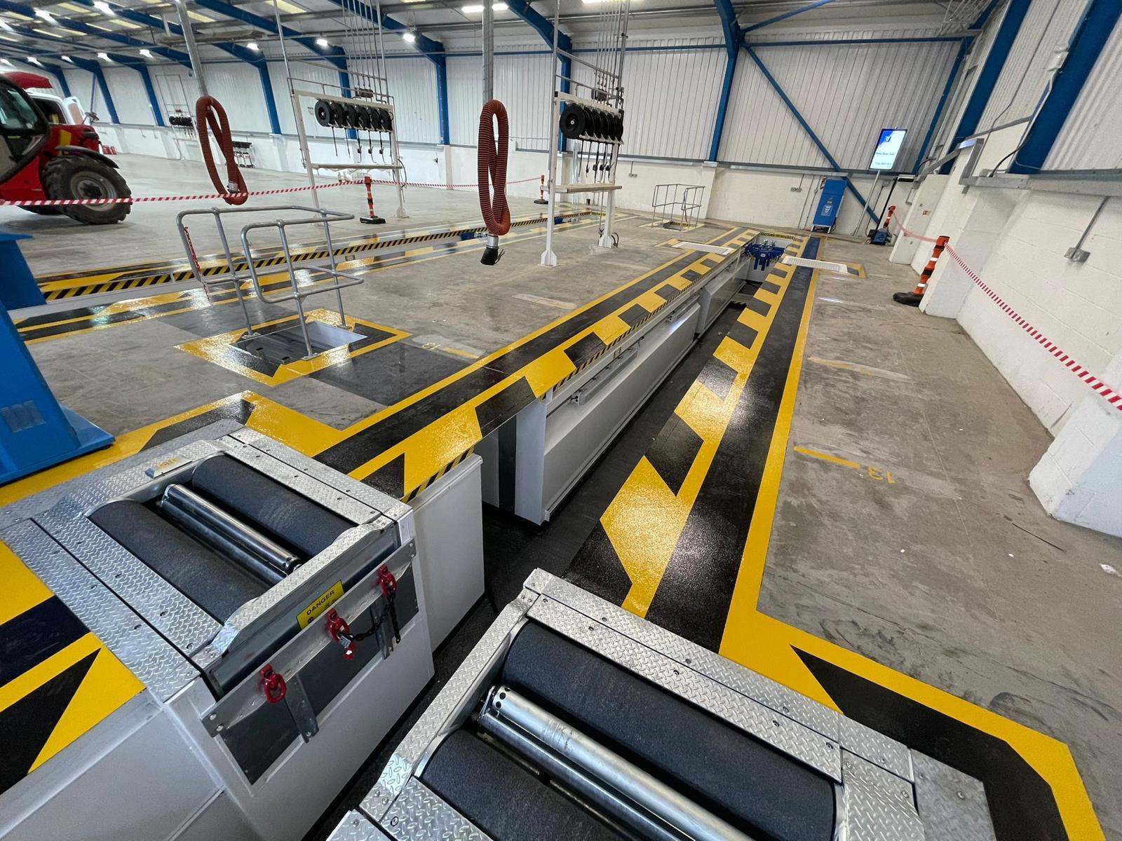 ATF test lanes with prefabricated steel inspection pits featuring yellow and black safety markings.