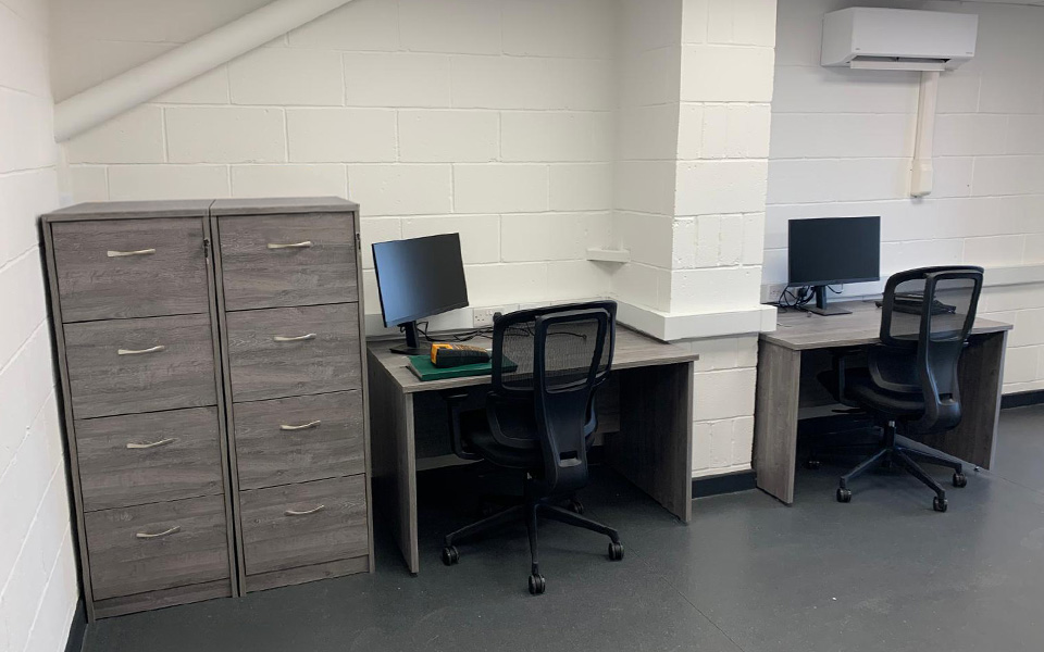 Office area with desk space, office chairs and document storage.