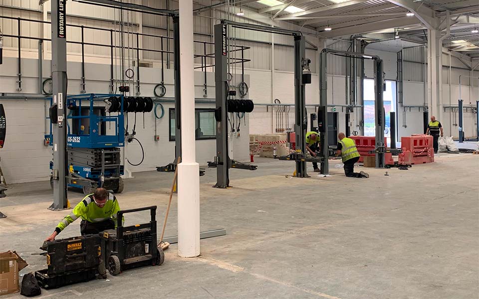 CCS team installing a fixed 2-post vehicle lift at the new Tyne & Wear Pain and Body Centre facility.