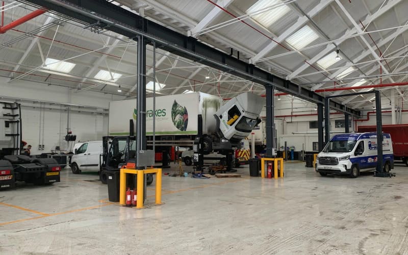 Interior of Adams Moreys new Eastleigh workshop featuring large transit vehicle.