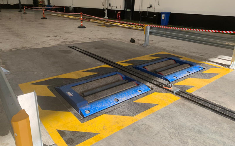 Simulated load brake testing technology installed at new Eastleigh workshop featuring black and yellow safety markings.