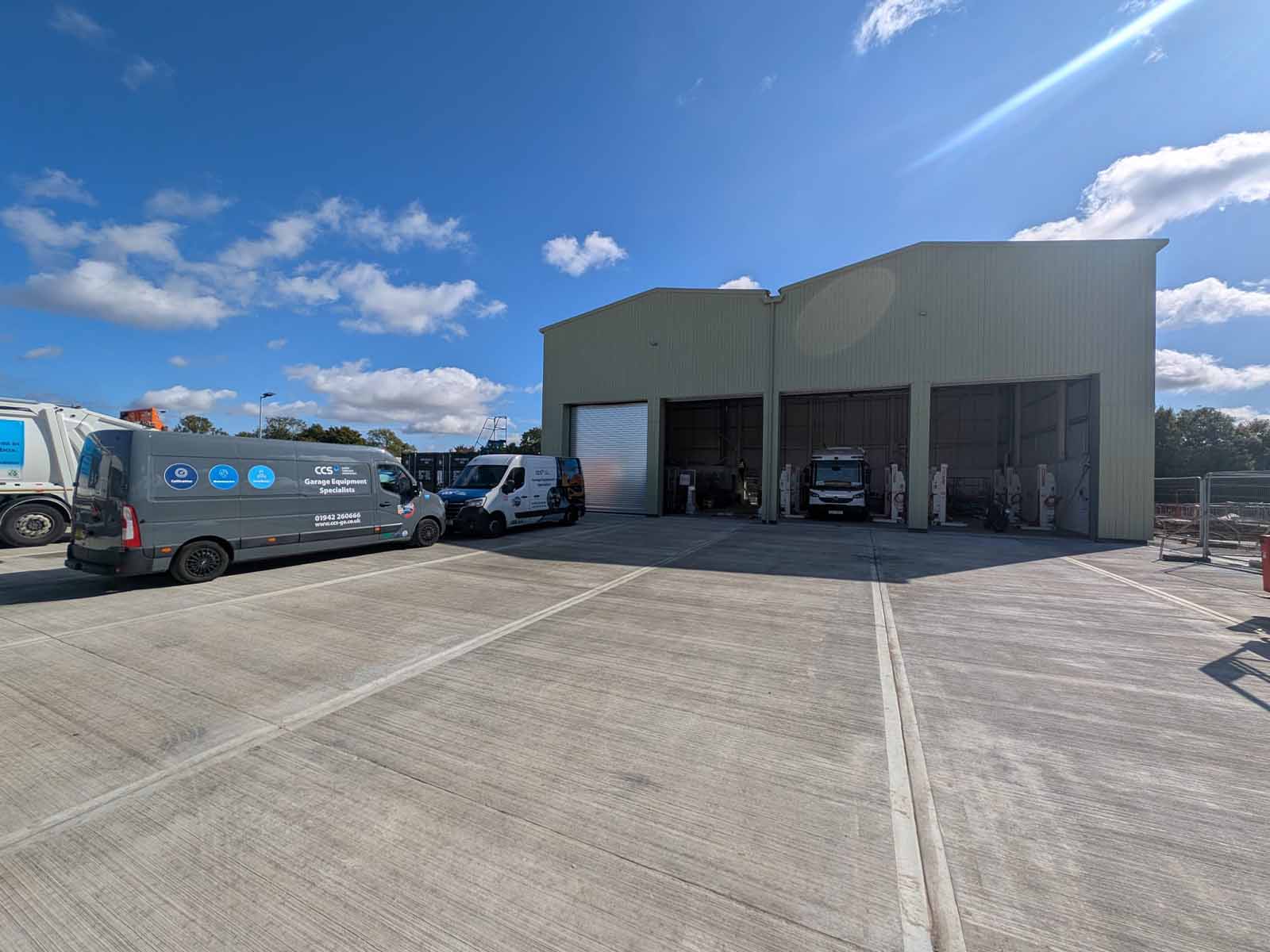 Exterior of new waste vehicle maintenance workshop featuring CCS vans.